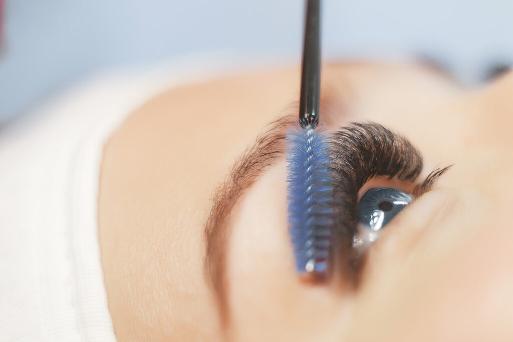Eye lash extensions with eye lash brush