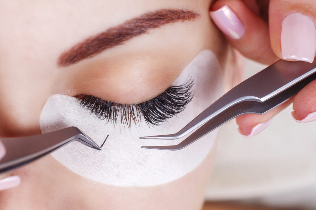 Putting lashes on for a lash service.